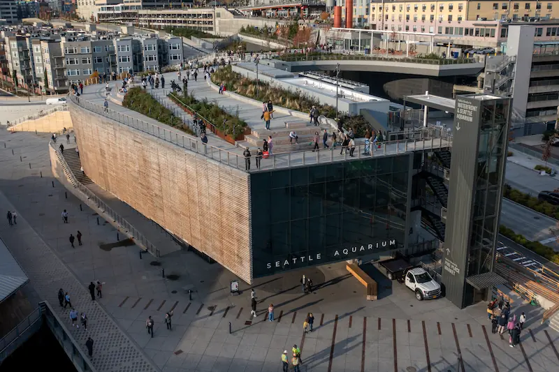 The Seattle Aquarium's Ocean Pavilion building viewed from above, featuring the rooftop park and other surrounding spaces.